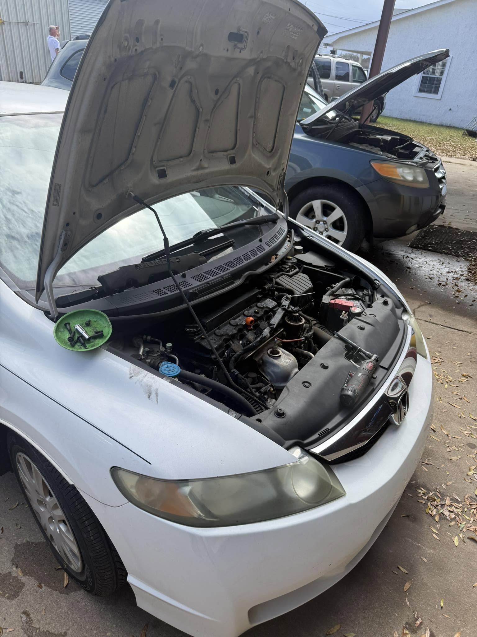 Mobile repair on a white sedan